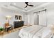 Brightly lit bedroom featuring a tray ceiling and sliding barn door at 15850 Viscount Cir, Port Charlotte, FL 33981