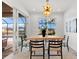 Bright dining area with elegant light fixture and views of the pool and outdoor living area at 15850 Viscount Cir, Port Charlotte, FL 33981