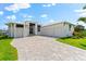 Charming home boasts a three-car garage, tiled driveway, and meticulously maintained landscaping at 15850 Viscount Cir, Port Charlotte, FL 33981