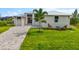 Charming home with well-manicured lawn and mature landscaping at 15850 Viscount Cir, Port Charlotte, FL 33981