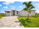 Beautiful home features a paved driveway and well-manicured lawn at 15850 Viscount Cir, Port Charlotte, FL 33981