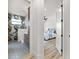 Hallway view into a bathroom with decorative accent wall and a main bedroom at 15850 Viscount Cir, Port Charlotte, FL 33981