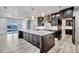 Open kitchen with a large island, designer hood vent, and access to additional prep areas and living spaces at 15850 Viscount Cir, Port Charlotte, FL 33981