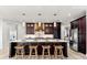 Modern kitchen features a large island with seating, stainless steel appliances, and stylish pendant lighting at 15850 Viscount Cir, Port Charlotte, FL 33981