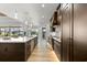 Spacious kitchen featuring an oversized island, custom cabinets, and stainless steel appliances at 15850 Viscount Cir, Port Charlotte, FL 33981