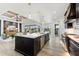 Bright, open kitchen with a large island, modern appliances, and a view of the outdoor living area at 15850 Viscount Cir, Port Charlotte, FL 33981