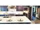 Open kitchen with island, stainless steel appliances, and dark cabinetry at 15850 Viscount Cir, Port Charlotte, FL 33981