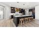 Modern kitchen with a large island, bar stool seating, designer fixtures, and stainless steel appliances at 15850 Viscount Cir, Port Charlotte, FL 33981