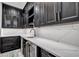 Modern wet bar with dark wood cabinets, light countertops, a sink, and a beverage refrigerator at 15850 Viscount Cir, Port Charlotte, FL 33981