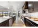 Gourmet kitchen with an island, gas range, custom hood, and plenty of counter space at 15850 Viscount Cir, Port Charlotte, FL 33981