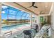 Relaxing screened lanai offers a private pool, comfortable seating, and stunning views of the canal at 15850 Viscount Cir, Port Charlotte, FL 33981