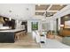 Open-concept living room flows into the kitchen and dining area, featuring stylish decor and a ceiling fan at 15850 Viscount Cir, Port Charlotte, FL 33981