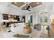 Stylish living area with contemporary furnishings, light wood flooring, and a clear view of the kitchen at 15850 Viscount Cir, Port Charlotte, FL 33981