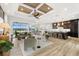 Open-concept living room with modern decor, wood-look flooring, and a seamless transition to the kitchen at 15850 Viscount Cir, Port Charlotte, FL 33981