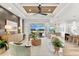 Bright, open living room with tray ceiling, stylish decor, and sliding glass doors to the outdoor pool and lanai at 15850 Viscount Cir, Port Charlotte, FL 33981