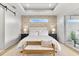 Well-lit main bedroom with a decorative wallpapered accent wall and stylish ceiling design at 15850 Viscount Cir, Port Charlotte, FL 33981