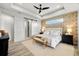 Main bedroom showcasing a decorative ceiling, accent wall, and a convenient sliding barn door at 15850 Viscount Cir, Port Charlotte, FL 33981