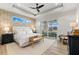 Bright main bedroom boasts decorative ceiling and wallpaper, with sliding doors to the screened in patio at 15850 Viscount Cir, Port Charlotte, FL 33981
