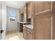 Well-organized mudroom with custom cabinets, counter space, and natural light at 15850 Viscount Cir, Port Charlotte, FL 33981
