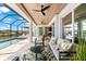 A relaxing outdoor patio features comfortable seating, tropical decor and an inviting place to enjoy the weather at 15850 Viscount Cir, Port Charlotte, FL 33981
