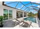 The perfect outdoor space offers relaxation and entertainment, featuring a screened-in pool and comfortable patio furniture at 15850 Viscount Cir, Port Charlotte, FL 33981