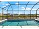 This stunning screened-in pool offers a refreshing escape with serene waterfront views, perfect for relaxation and recreation at 15850 Viscount Cir, Port Charlotte, FL 33981