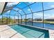A stunning screened-in pool overlooking the canal, perfect for relaxation and enjoyment at 15850 Viscount Cir, Port Charlotte, FL 33981