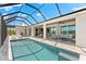 A spacious screened-in pool area with comfortable seating is the perfect space for relaxation and entertainment at 15850 Viscount Cir, Port Charlotte, FL 33981