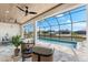 A screened in lanai features a beautiful pool overlooking a serene waterway with nice patio furniture at 15850 Viscount Cir, Port Charlotte, FL 33981