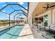 Inviting outdoor living with a screened lanai, featuring a private pool and views of the waterfront at 15850 Viscount Cir, Port Charlotte, FL 33981