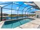 Enjoy the tranquil waterfront views from this beautiful screened-in pool area, perfect for relaxation and entertainment at 15850 Viscount Cir, Port Charlotte, FL 33981