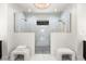 Luxury shower with dual shower heads, glass enclosures, and decorative tile, complemented by seating at 15850 Viscount Cir, Port Charlotte, FL 33981