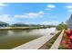 Waterfront canal view with lush landscaping and a cozy fire pit area at 15850 Viscount Cir, Port Charlotte, FL 33981