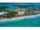 Beautiful beach with white sand and turquoise ocean water, showcasing beachfront property at 1605 Manor Rd, Englewood, FL 34223