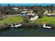 Aerial view of a charming home with a dock and boat on a serene waterway at 1605 Manor Rd, Englewood, FL 34223