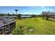 Large, green backyard with waterfront view seen from the screened-in lanai at 1605 Manor Rd, Englewood, FL 34223