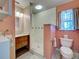Bathroom featuring a tiled shower, marble vanity and tiled floors at 1605 Manor Rd, Englewood, FL 34223
