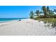 Beautiful beach with white sand, blue water and sparse beach goers at 1605 Manor Rd, Englewood, FL 34223