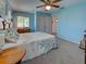 Bedroom featuring a bed and windows, complemented by blue walls and cozy carpet at 1605 Manor Rd, Englewood, FL 34223