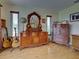 This bedroom showcases hardwood floors, wooden furniture, and natural light from the windows at 1605 Manor Rd, Englewood, FL 34223