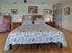 Spacious bedroom featuring wood flooring, a ceiling fan, and traditional wooden furniture at 1605 Manor Rd, Englewood, FL 34223