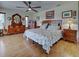 Spacious bedroom featuring wood flooring, a ceiling fan, and traditional wooden furniture at 1605 Manor Rd, Englewood, FL 34223