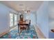 Dining room featuring hardwood chairs and a beautiful area rug at 1605 Manor Rd, Englewood, FL 34223