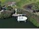 Aerial shot of a boat lift at a private dock, surrounded by lush greenery at 1605 Manor Rd, Englewood, FL 34223