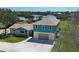 Waterfront home with a two-car garage and well-maintained lawn at 1605 Manor Rd, Englewood, FL 34223