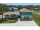 An exterior view of a well-maintained home with a spacious front yard at 1605 Manor Rd, Englewood, FL 34223