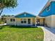 Charming home exterior featuring a lush green lawn and cozy front porch at 1605 Manor Rd, Englewood, FL 34223
