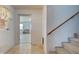 Hallway featuring stairwell and a view into the living room at 1605 Manor Rd, Englewood, FL 34223