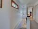 Hallway with stained glass window above the staircase leading to the main level at 1605 Manor Rd, Englewood, FL 34223