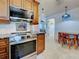 Modern kitchen featuring stainless steel appliances and granite countertops at 1605 Manor Rd, Englewood, FL 34223
